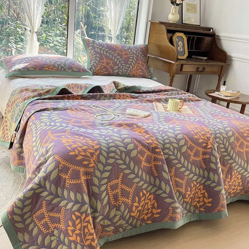 Wendesteppdecke aus Baumwolle mit grünen und orangefarbenen Blättern