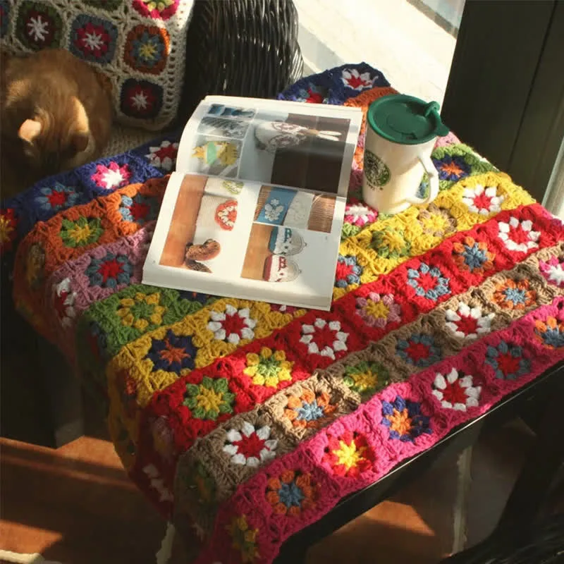 Handgewebte, funktionelle Häkeldecke mit leuchtenden Gänseblümchen
